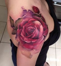 a woman with a rose tattoo on her shoulder