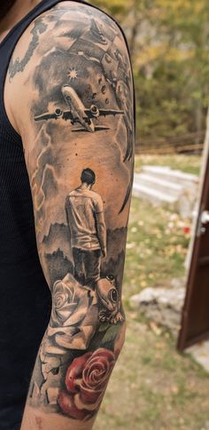 a man's arm with an airplane and roses on it