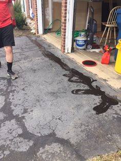 a man standing in front of a garage next to a fire hydrant and hose