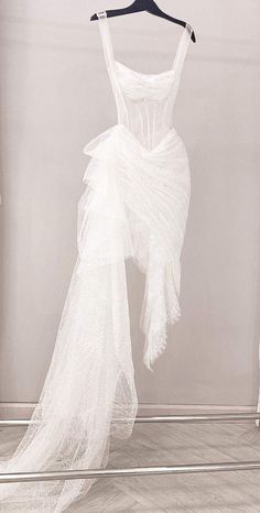 a white dress hanging on a hanger