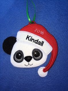 a panda bear ornament with a santa hat on it's head that says kinddall