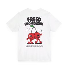 Step back in time with a touch of playful nostalgia with our "Freed From Desire" t-shirt. This vintage-inspired tee features the iconic phrase "Freed From Desire" paired with a whimsical illustration of two cherries dancing joyfully. The retro cartoon cherries bring a fun, carefree vibe, symbolizing the liberation and joy. The design, with its vibrant colors and vintage charm, stands out against the fabric, making it a statement piece that echoes both style and a deeper message of freedom from s Graphic Tee With Logo For Music Festivals, Music-themed Text Print T-shirt For Streetwear, Graphic Tee With Logo Print For Music Festivals, White Music-themed T-shirt With Text Print, Retro Music Festival T-shirt With Text Print, Retro Text Print T-shirt For Music Festivals, White Graphic Tee For Music Festival, White T-shirt With Text Print For Music Festivals, White Text Print T-shirt For Music Festivals