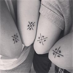 three people with matching tattoos on their arms