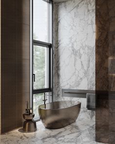 a bathtub sitting next to a window in a room with marble walls and floors