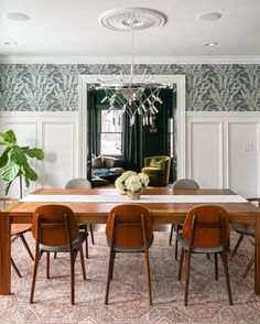 a dining room table with chairs and a chandelier