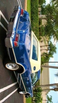 a blue car parked on the side of a road