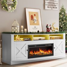 an entertainment center with a fireplace and christmas decorations