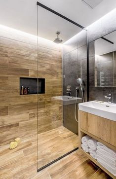 a modern bathroom with wooden flooring and walls