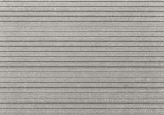 a gray wall with vertical blinds in the middle and horizontal lines on the bottom, as if it were made out of concrete