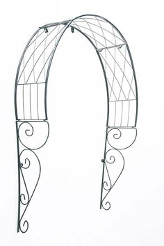 an iron arch with scroll work on the top and bottom, against a white background