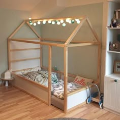 a child's bedroom with a doll house bed in the middle and shelves on both sides