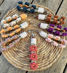 a wicker basket filled with lots of different bracelets on top of a wooden table