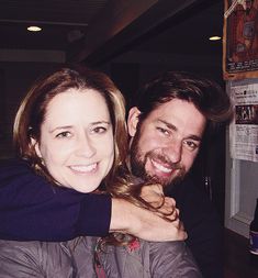 a man and woman hugging each other at a bar