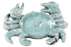 a ceramic crab with two smaller crabs on it's back