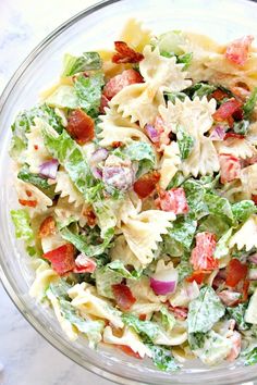 a bowl filled with pasta salad on top of a table