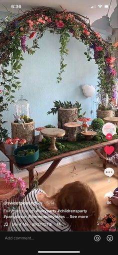 there is a table with many plants and flowers on it, including succulents