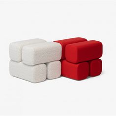 three different colored couches sitting next to each other on a white surface with one red and the other white