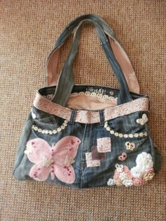 a handbag that is on the ground with some flowers and butterflies painted on it