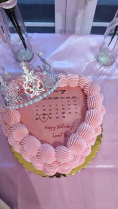 a pink birthday cake with a tiara on top