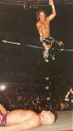 a wrestler is suspended in the air by his opponent