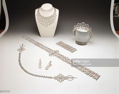 an assortment of jewelry is displayed on a table