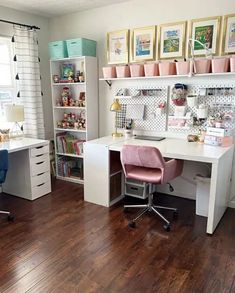 a home office with white desks and pink chairs