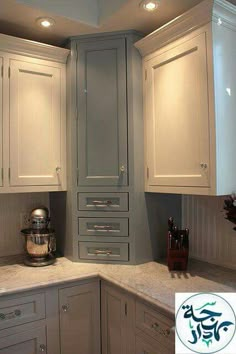 a kitchen with white cabinets and granite counter tops