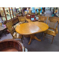 a large wooden table surrounded by chairs and other furniture