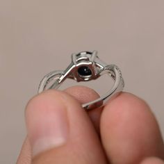 This is a gorgeous handmade creation. Its beauty is its simplicity & Elegance. The 7*7 mm round shape faceted natural Black Spinel is crafted in solid sterling silver and with rhodium plated. All item is sent in a beautiful gift box If you have any idea of design your ring,pls contact me directly. You can realize more lovely stuff clicking the link https://www.etsy.com/shop/knightjewelry?refshopsection_shophome_leftnav Please leave the correct address and you phone number for delivering succ Diamond Halo Ring With Round Stone As Gift, Black Birthstone Ring Gift, Black Birthstone Rings For Anniversary, Black Birthstone Rings For Gifts, Black Birthstone Rings, Black Diamond Ring With Halo Setting For Gift, Adjustable Round Sapphire Promise Ring, Adjustable Round Sapphire Anniversary Ring, Cubic Zirconia Sapphire Ring Gift