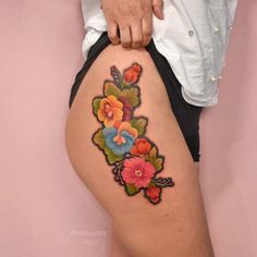 a woman's thigh with flowers on it