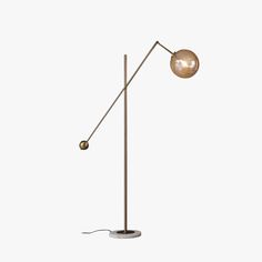 a floor lamp that is standing up on a white background, with the light turned off