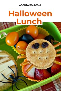 halloween lunch with fruit, cheese and crackers in the shape of a spider on a green tray