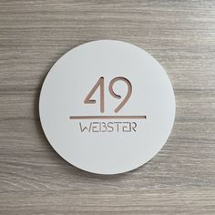 a white round sign with the number forty nine on it that reads,'we are here in weister '