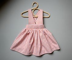 "Sizes: 0-3 Months to 7-8 Years Formats: A4/Letter, A0 and Projector Skill: Intermediate Iris is a high waist suspender skirt designed for light to medium weight woven fabric. The criss-cross straps have adjustable length and unbutton in the back and front. Skirt is gathered at the top and features adorable patch pockets with a faux flap. Perfect to wear over a shirt or blouse. Skirt length is designed to fall approximately 1-2\" (2.5 - 5 cm) below the knee. After completing your purchase you wi Tank Top Sewing Pattern, Pinafore Skirt, Sewing Patterns Girls, Blouse Skirt, Garment Pattern, Dress Tutorials, Baby Sewing Patterns, Suspender Skirt, Popular Dresses