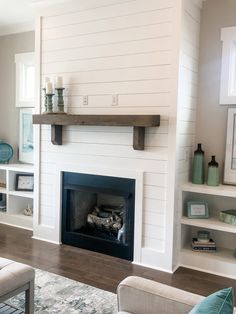 a living room filled with furniture and a fire place in the middle of a room