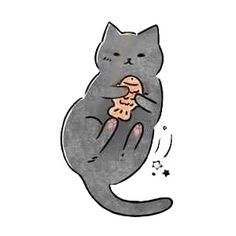 a cat that is sitting down eating some kind of food in it's paws