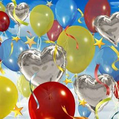 many heart shaped balloons floating in the air with stars and confetti on them