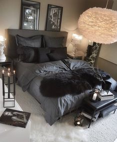 a black and white bedroom with fur rugs on the floor