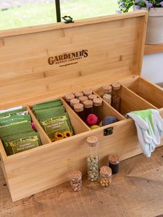 a wooden box filled with lots of different types of spices and condiments on top of a table