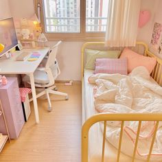 a small child's bedroom with a bed, desk and computer