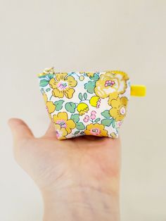 "100% Cotton. Lightweight. From the world famous Liberty Fabrics with a silk-like touch, unique print quality and striking color vibrancy. This mini pouch is great size for a couple of small items. Size is 3\"W / 2.5\"H / 1.25\"D (8cm / 6cm / 3cm) Flat bottom shape. Fabric is Liberty of London Tana Lawn / Exclusive print. Imported from UK. The pouch opens with golden color zipper.(High quality YKK zipper) It comes with a velvet ribbon on one side. Lined inside with pretty yellow color cotton. Pl Yellow Zipper Pouch Coin Purse For Daily Use, Yellow Zipper Pouch Cosmetic Bag, Yellow Pouch Coin Purse For Travel, Yellow Zipper Pouch For Personal Use, Yellow Coin Purse With Zipper For Everyday Use, Yellow Pouch Pencil Case Gift, Yellow Pouch Pencil Case As Gift, Yellow Pouch Cosmetic Bag Gift, Yellow Pouch Cosmetic Bag For Gift