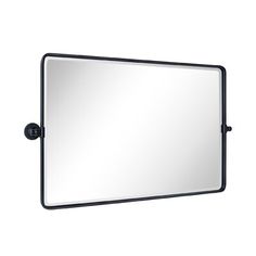 a large mirror mounted on the wall with a black frame and metal fittings to it