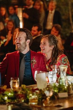 a man and woman sitting at a dinner table