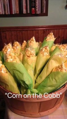 a basket filled with corn sitting on top of a table