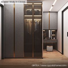 a walk in closet with glass doors and clothes hanging on hangers next to it