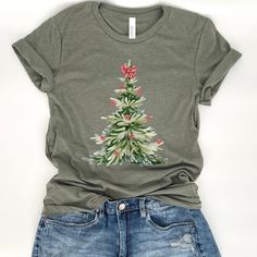 Christmas tree women's t-shirt, Holiday tee for ladies, Watercolor graphic, Christmas gift for her, Red and white bows, Winter top, Holiday party tee, Holiday top, Gift for mom, Gift for daughter, Gift for wife, Gift for teen, Gift for sister, Gift for grandma, Bella Canvas At ATTA TOOD, we offer a wide range of tees - from faith-based to family, funny, holiday, and beyond. Our faith is the foundation of our shop, but let's be real... we love to sprinkle in a little sass too!  ATTA TOOD tees are Christmas Cotton T-shirt With Screen Print, Holiday Custom Print Short Sleeve Tops, Holiday Tops With Custom Print And Short Sleeves, Red Screen Print Tops As Gift, Red Screen Print Tops As A Gift, Green Short Sleeve Holiday Top, Christmas Graphic Tee As Gift, Christmas Graphic Tee Shirt Gift, Christmas Graphic Tee T-shirt As Gift