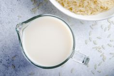 a glass of milk next to a bowl of oatmeal