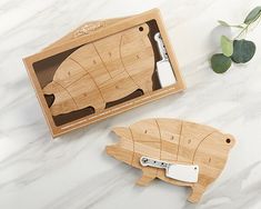 two wooden cutting boards with cut out animals on them