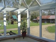 the inside of a house with large windows looking out onto a playground and play area