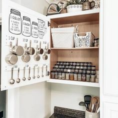 an organized pantry with pots and pans on the shelves, including utensils